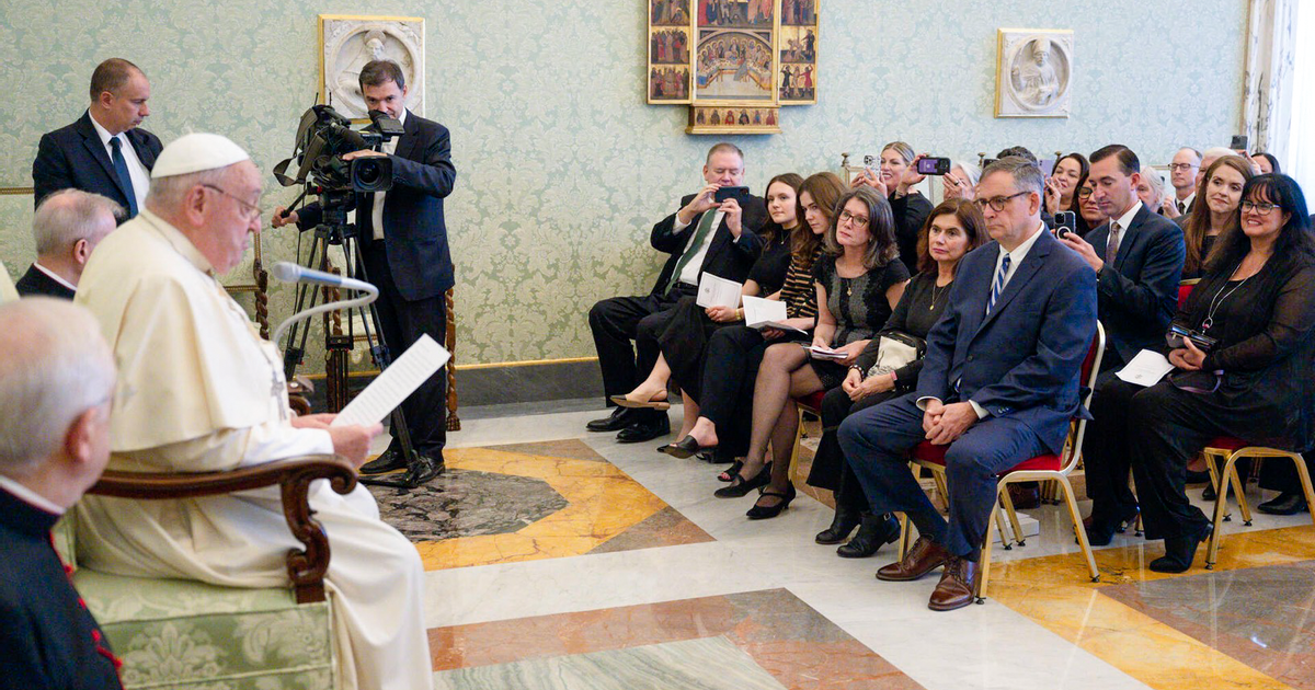 CCF President Anne Cullen Miller sits amid audience memers while Pope Francis delivers a verbal message