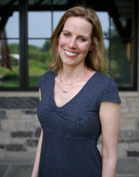 Jackie Gibney smiles in front of her home.