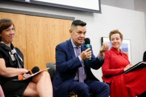 Luis Fraga speaks while making emphatic hand gesture as Jean Houghton and Gail Dorn look on