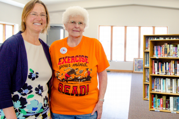 Librarians smile in sunny library