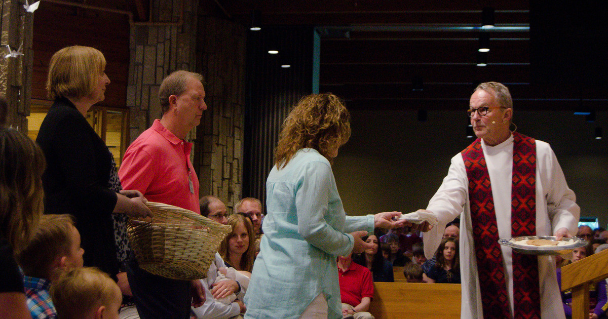 priest accepts gifts at the altar