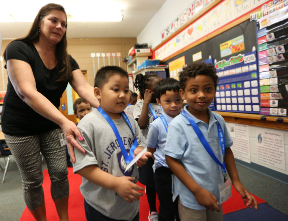 School children stand in line in classroom